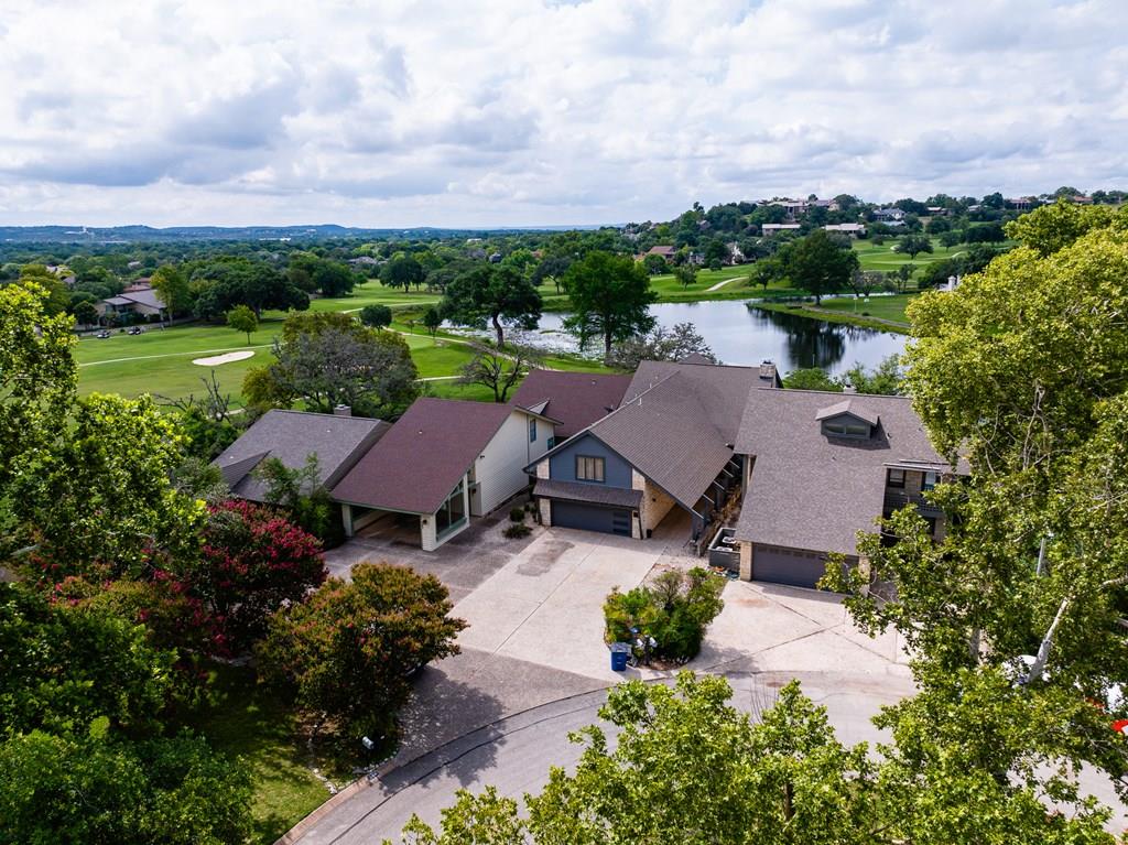 an aerial view of a house with garden space and street view