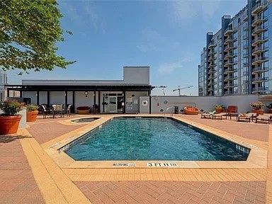 a view of swimming pool with outdoor seating