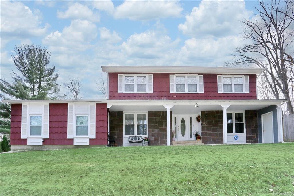 front view of a brick house with a yard