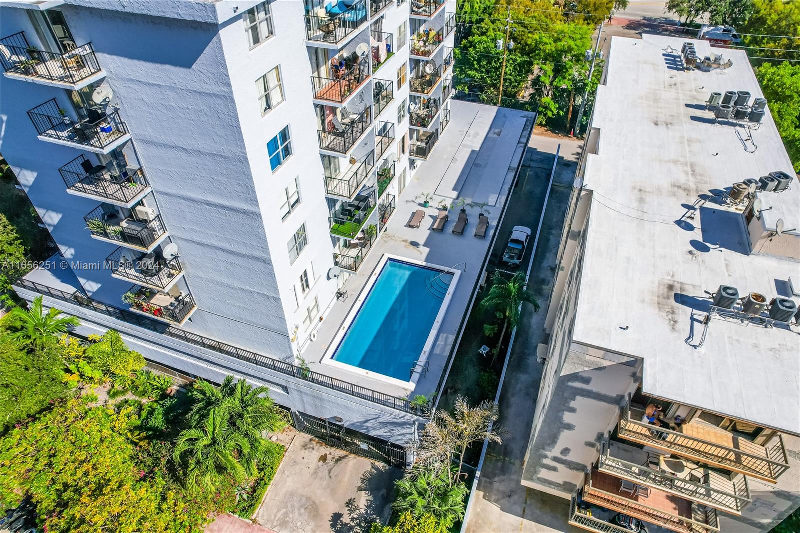 an aerial view of a residential apartment building with a yard