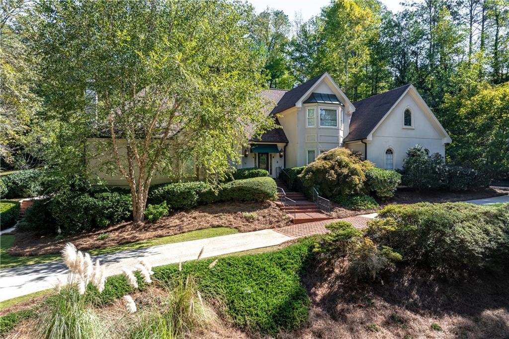 a front view of a house with a yard and pathway