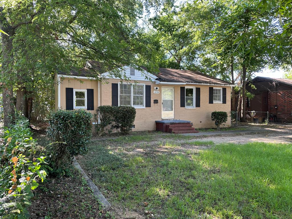 a house that has a tree in front of it