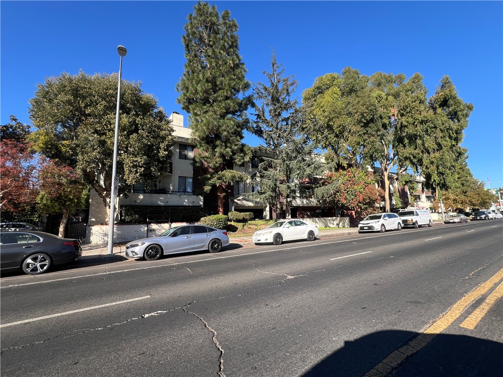 a view of a cars parked on the side of a street