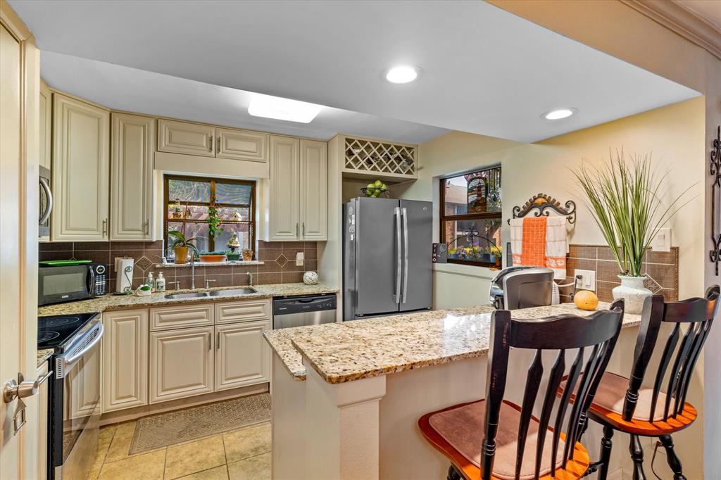 a kitchen with a table chairs refrigerator and cabinets