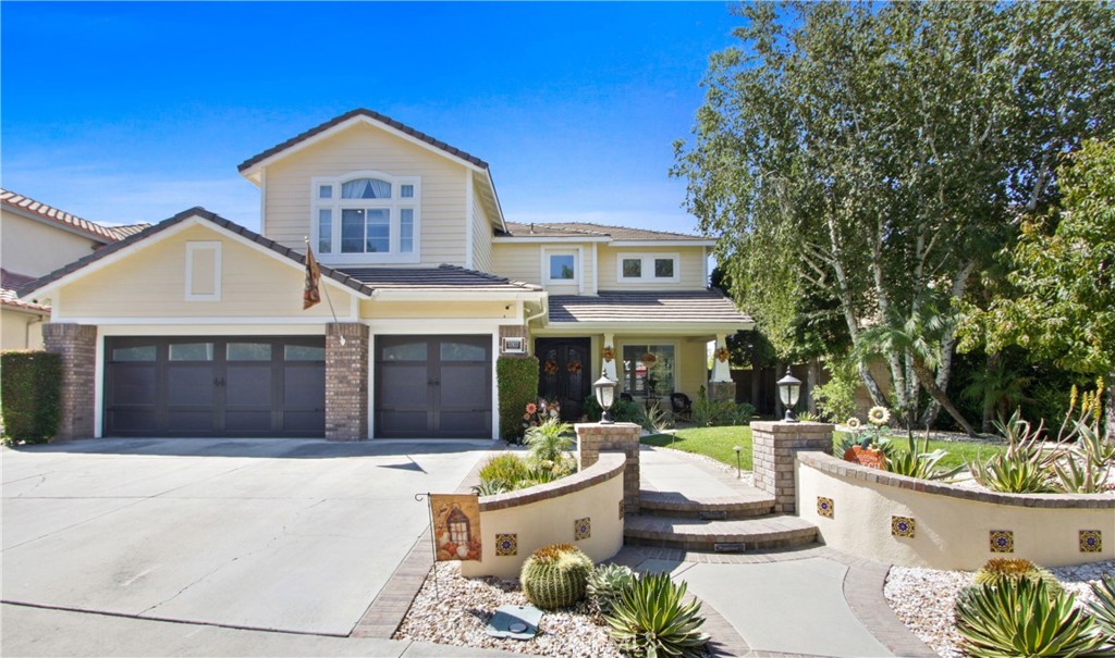 a front view of a house with a garden and patio