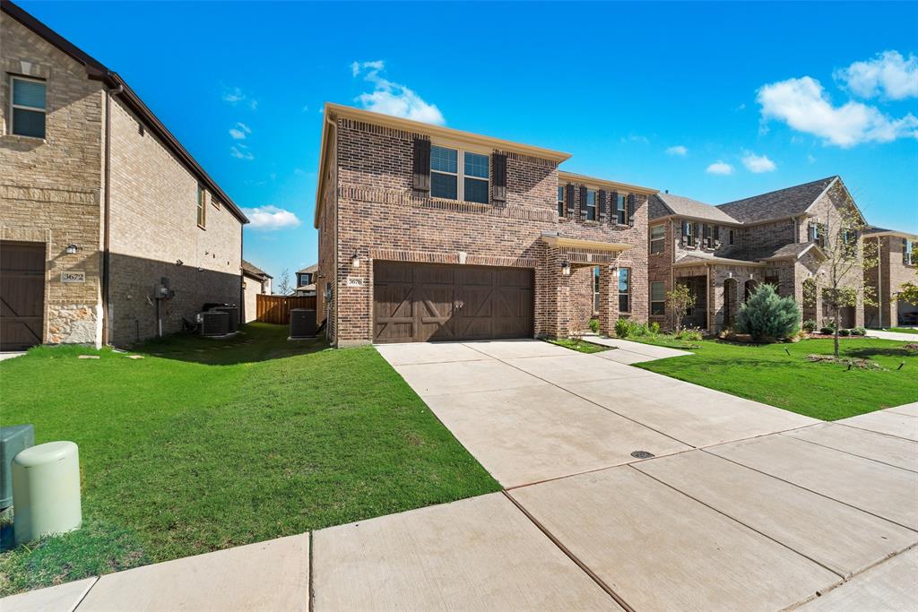 a front view of a house with a garden and yard