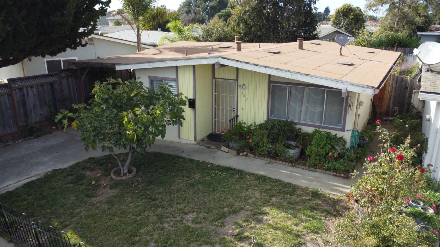 a view of a house with a yard and sitting area