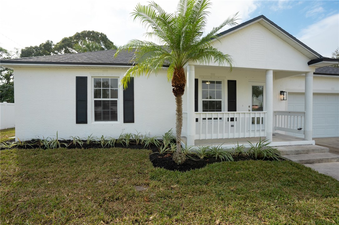 a front view of a house with a garden