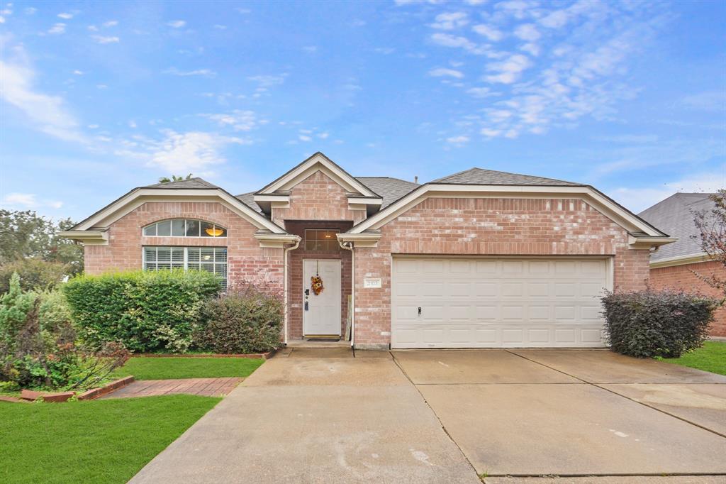 Charming single-story brick home with a two-car garage, a welcoming front porch, and neatly landscaped yard. Ideal for comfortable suburban living.