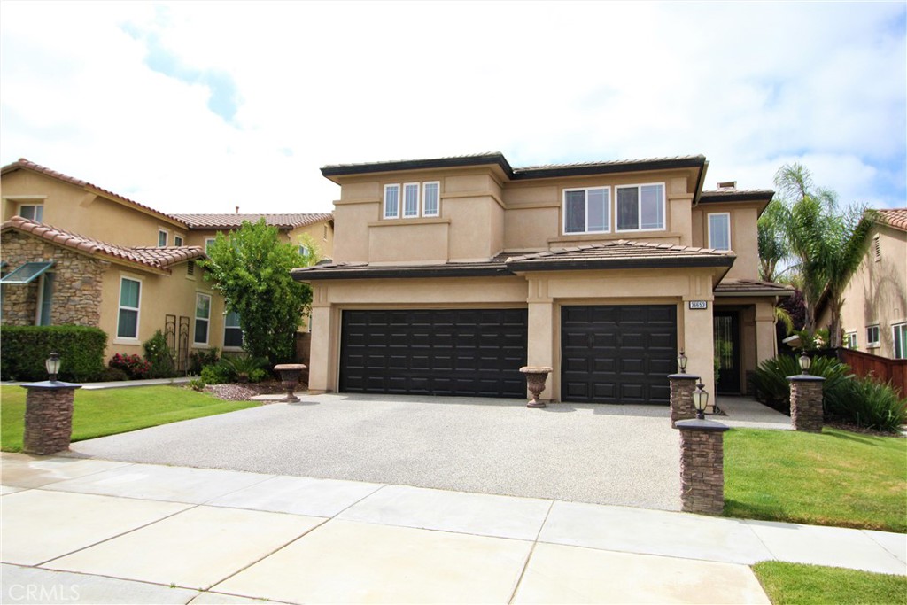 a view of a house with a yard and garage