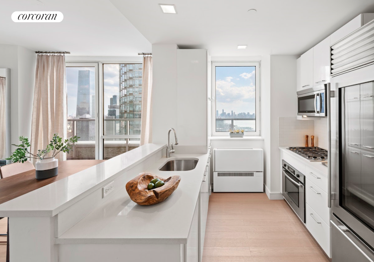 a kitchen with stainless steel appliances a sink and a large window