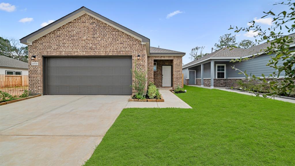 a front view of a house with a garden and yard