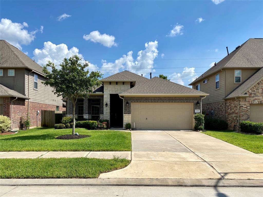 a front view of a house with a yard and garage