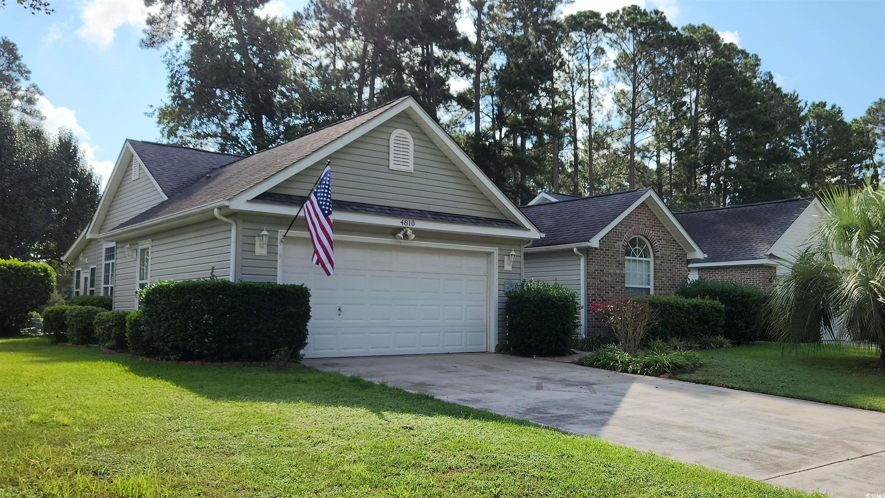 Ranch-style house with a front lawn and a garage