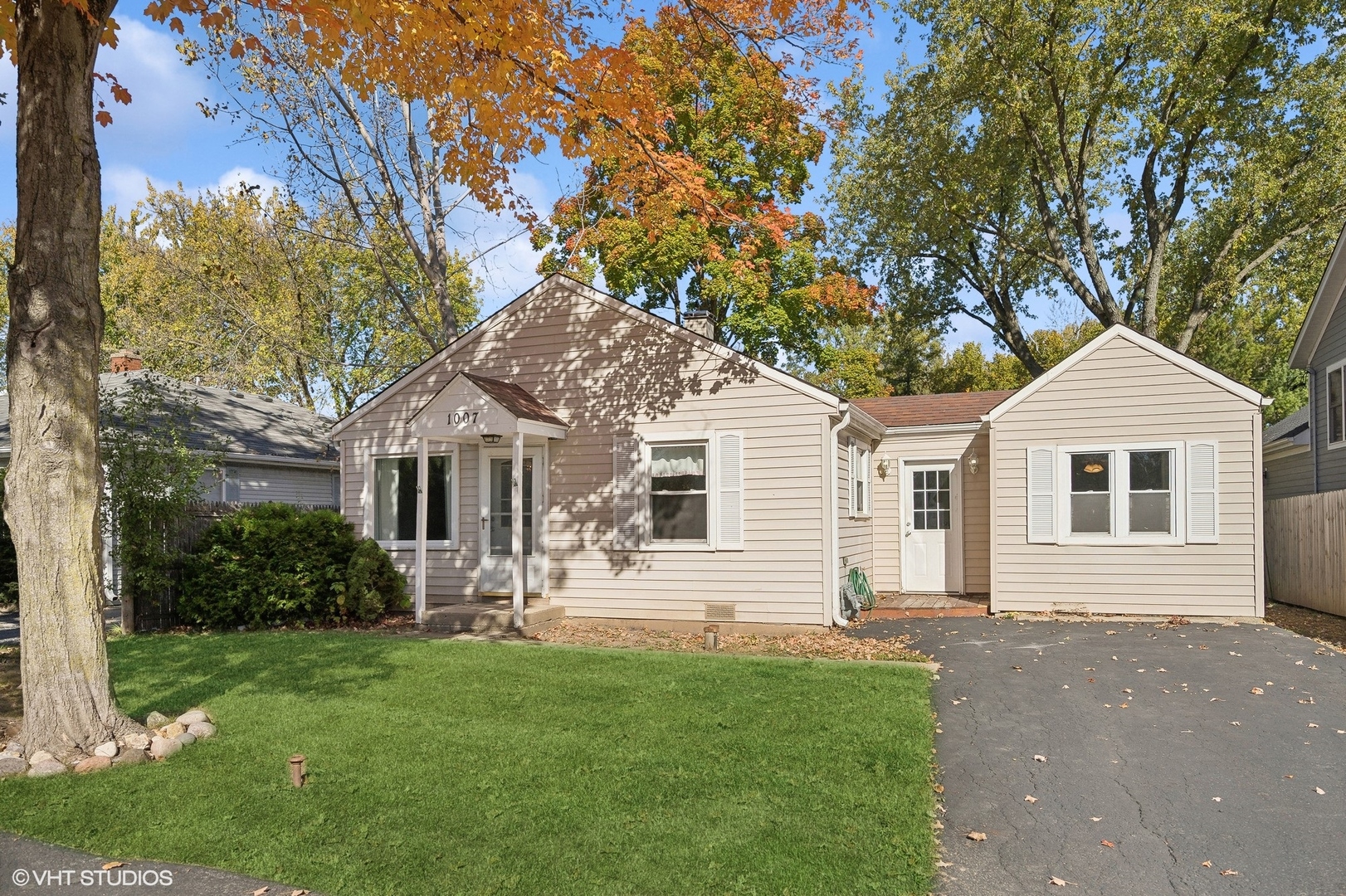 a front view of house with yard and green space