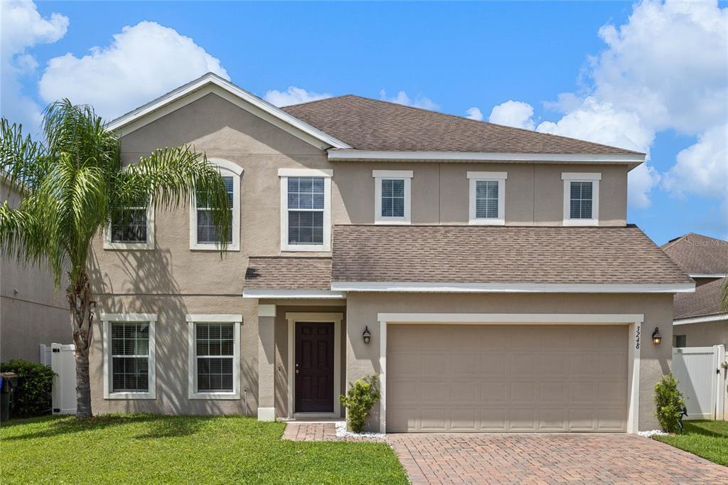 a front view of a house with a yard and garage