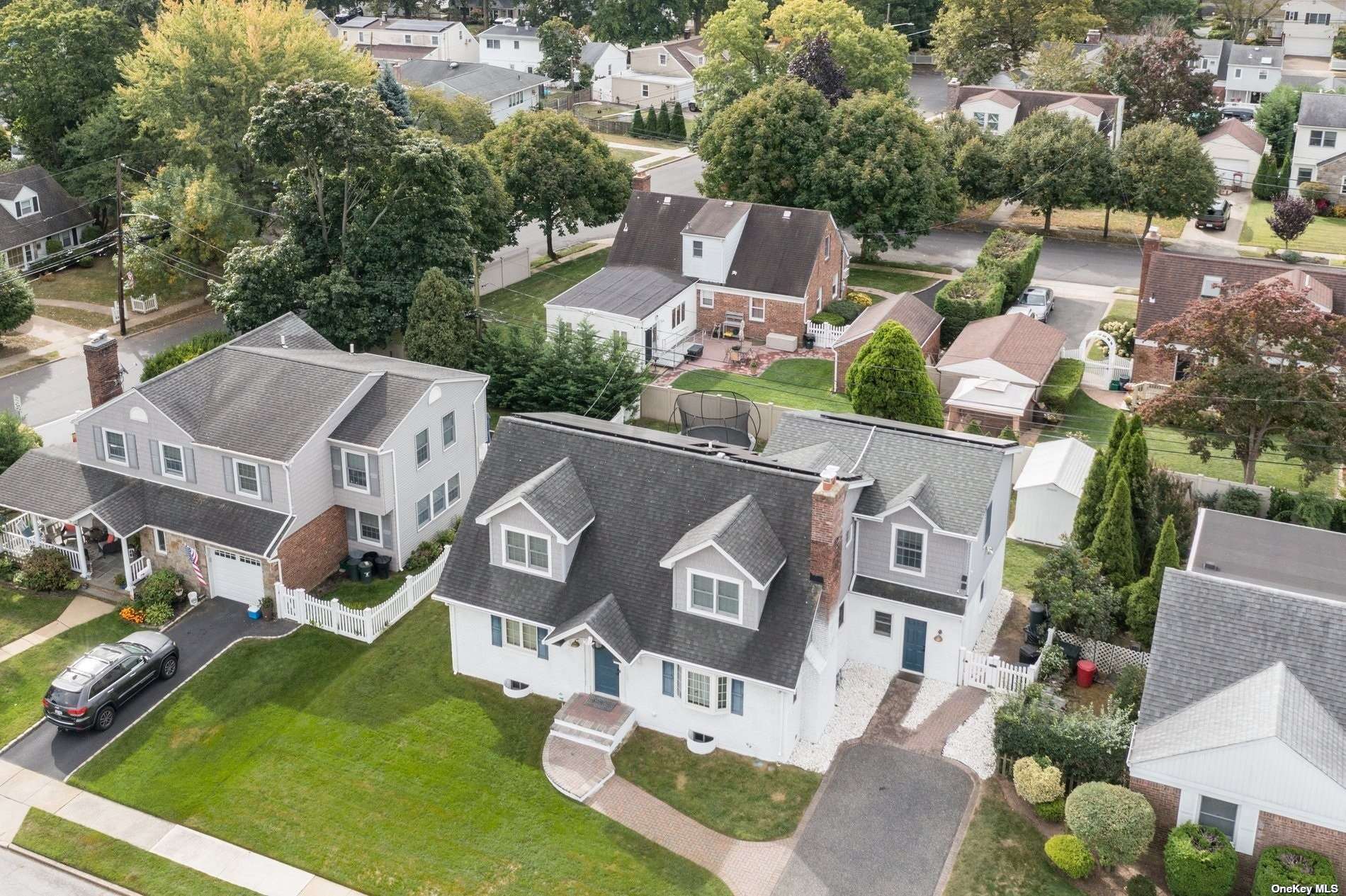 an aerial view of residential house with outdoor space and parking