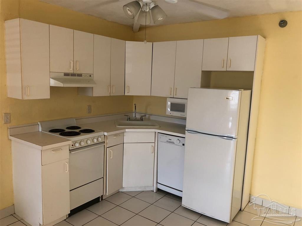 a white refrigerator freezer sitting inside of a kitchen