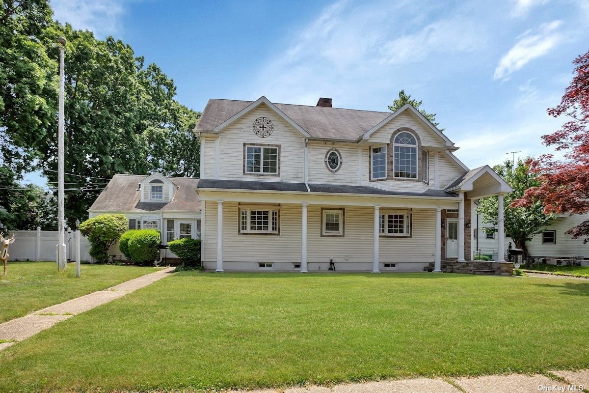 a front view of house with yard and green space