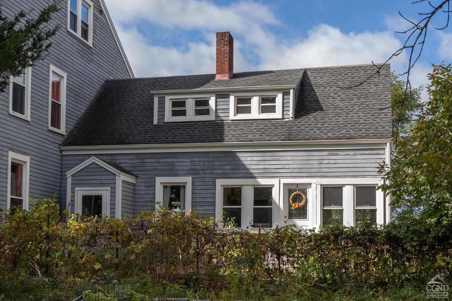 a front view of a house with plants