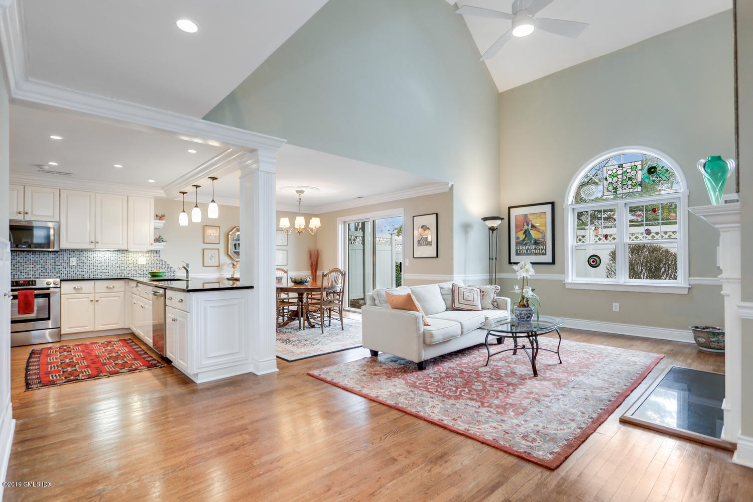 a living room with furniture wooden floor and a large window