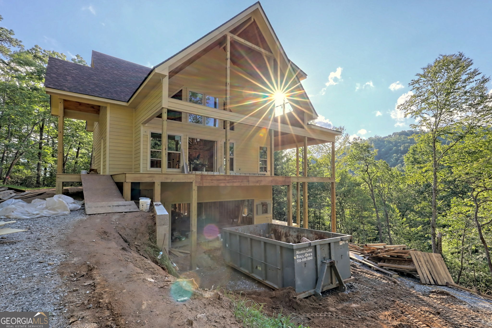 a view of a house with backyard and sitting area