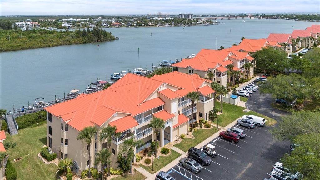 an aerial view of residential houses with outdoor space and lake view