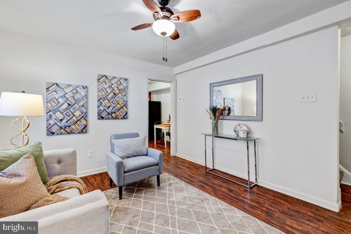 a living room with furniture and wooden floor