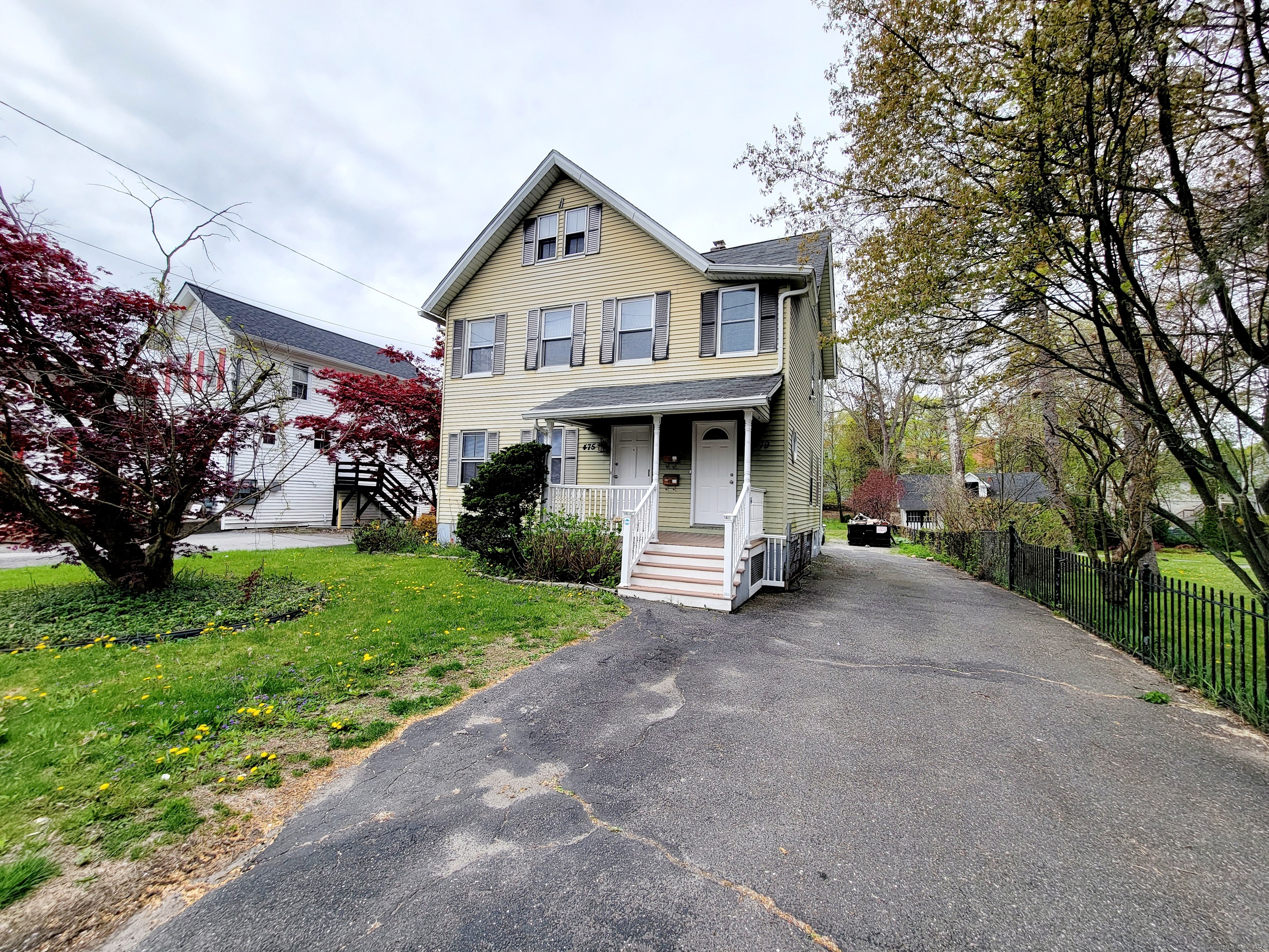 a view of a house with yard and tree s