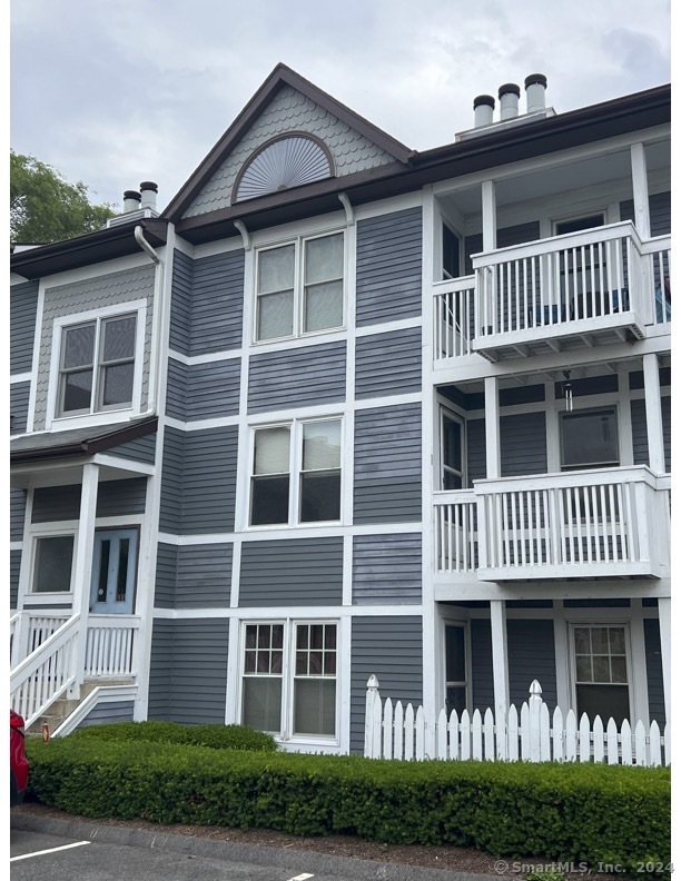 a view of an apartment with large windows and a yard