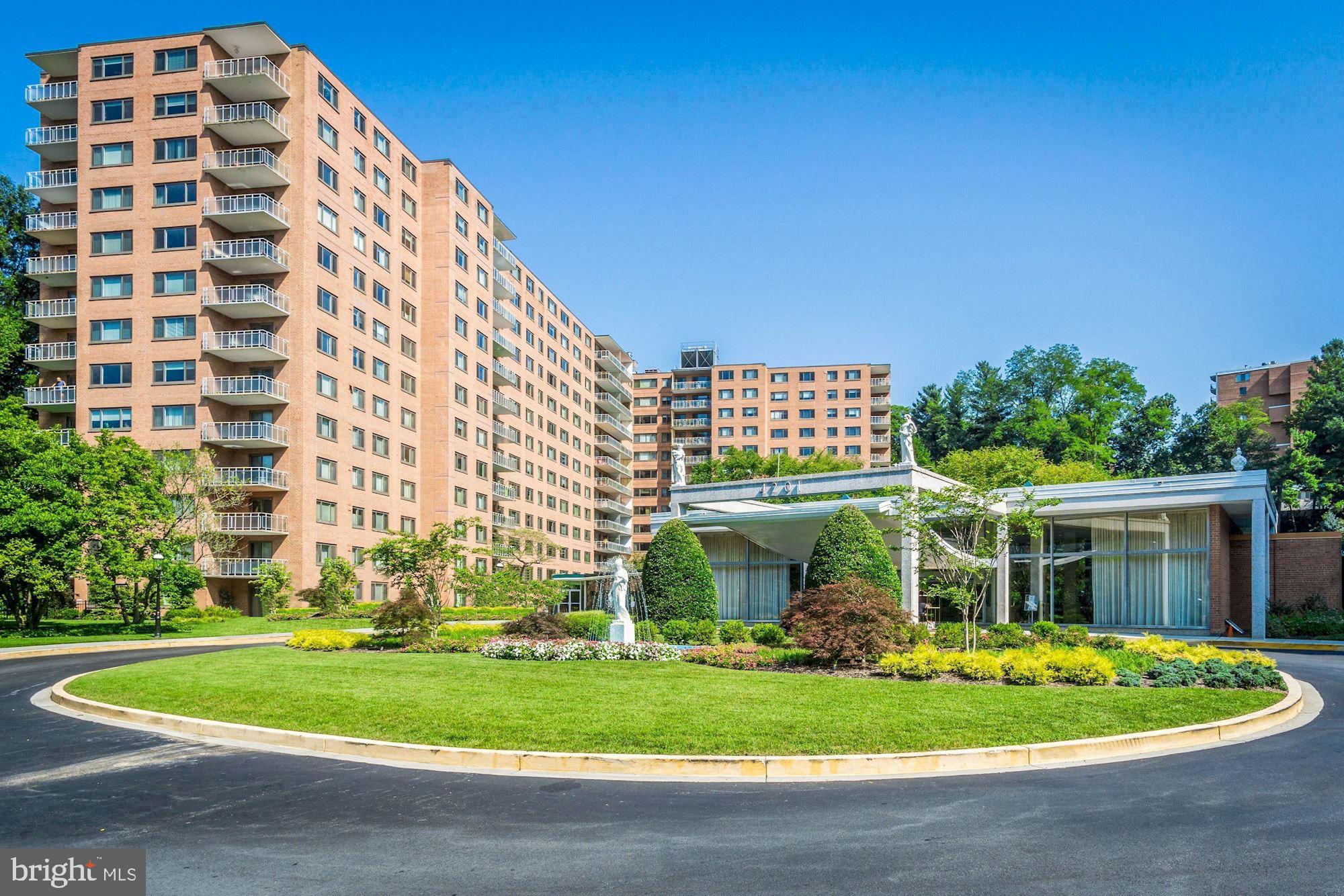 a front view of a building with a garden