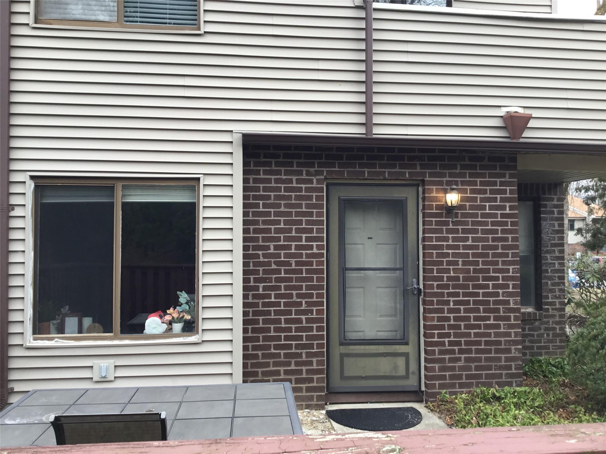 a small white building with a window