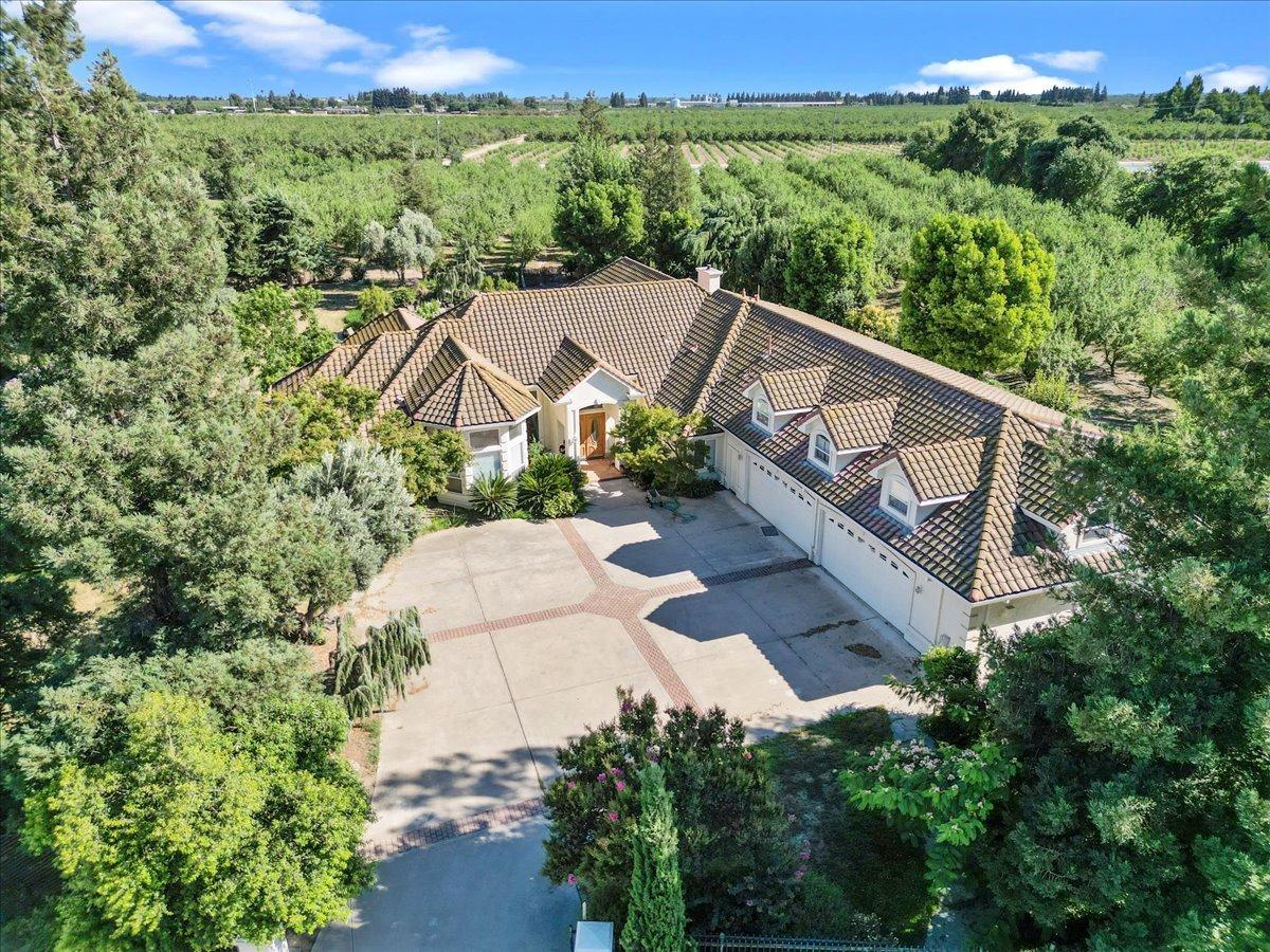 an aerial view of a house with a yard and lake view