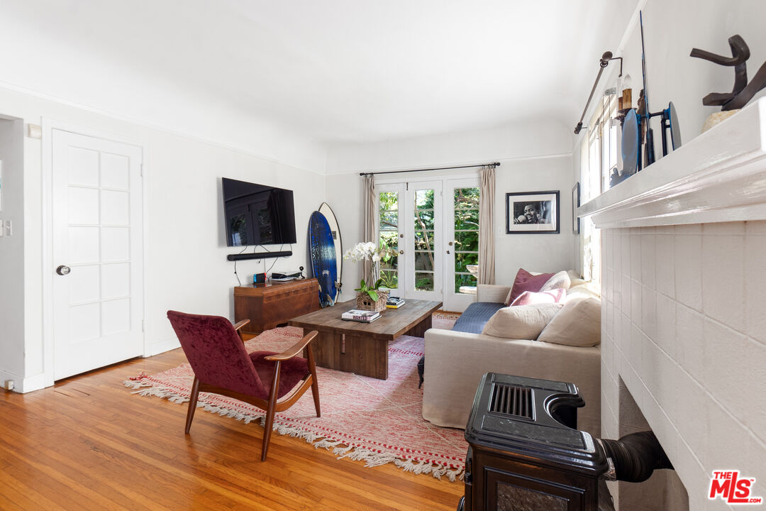 a living room with furniture a flat screen tv and a window