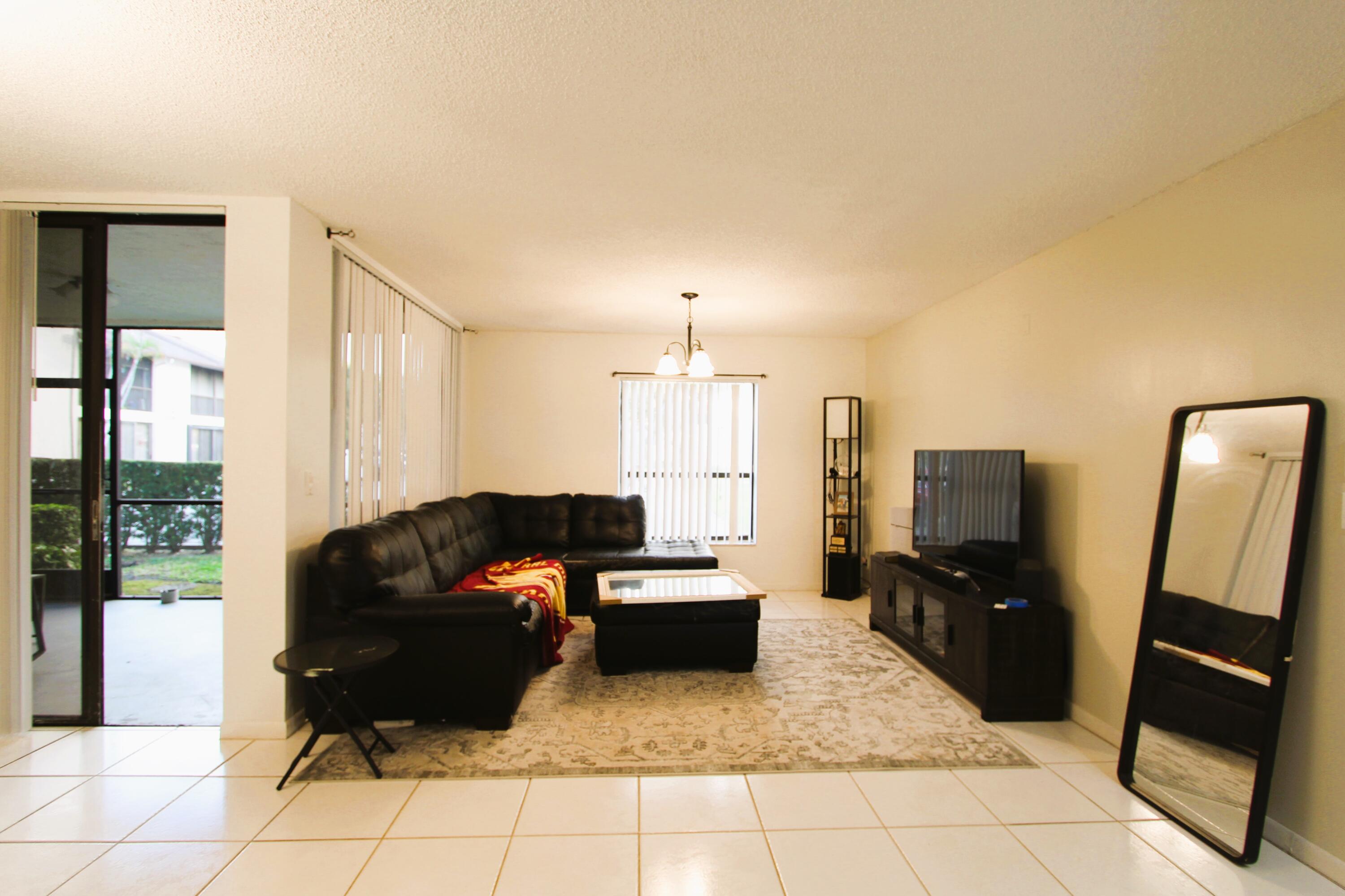 a living room with furniture and a mirror