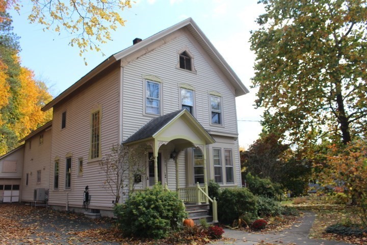 a view of a house with a yard and plants