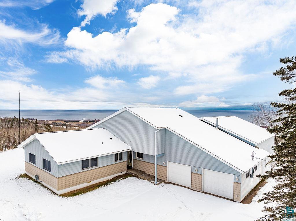 Snowy aerial view with a water view