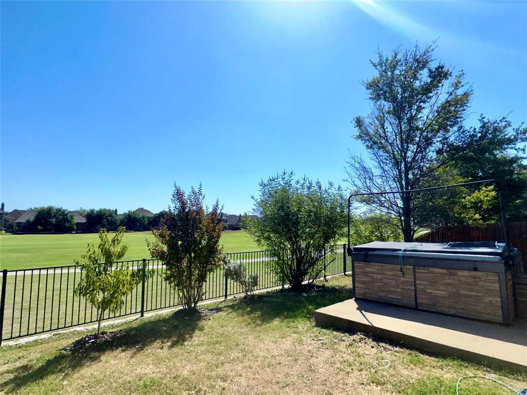 a view of a yard with wooden fence