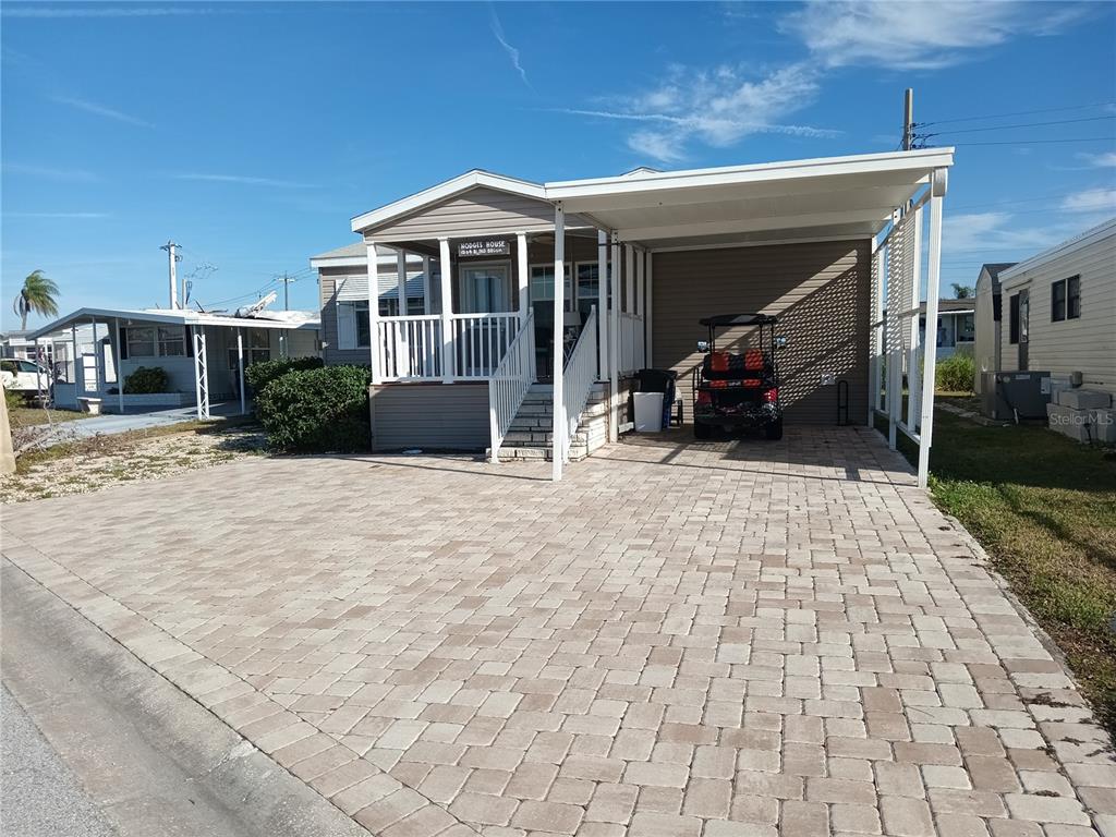 a view of a house with backyard and porch