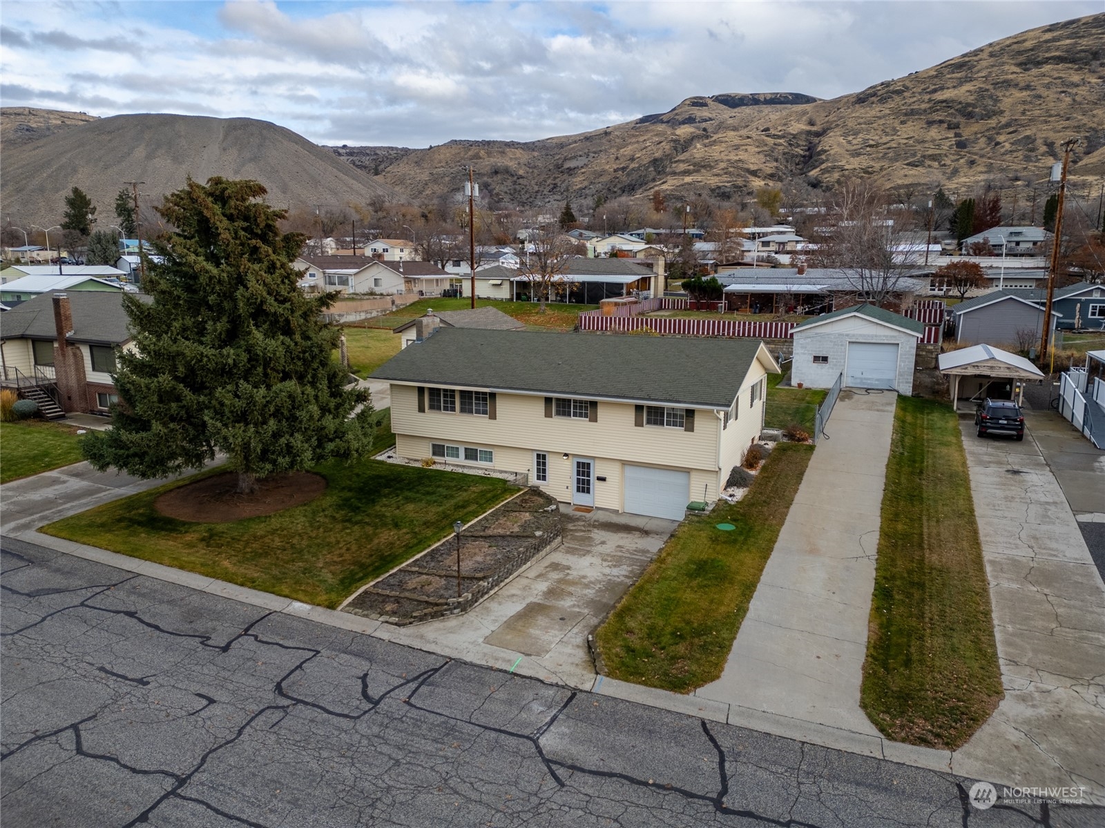 an aerial view of a house with a yard