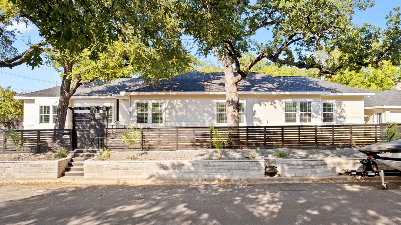 a front view of a house with a tree