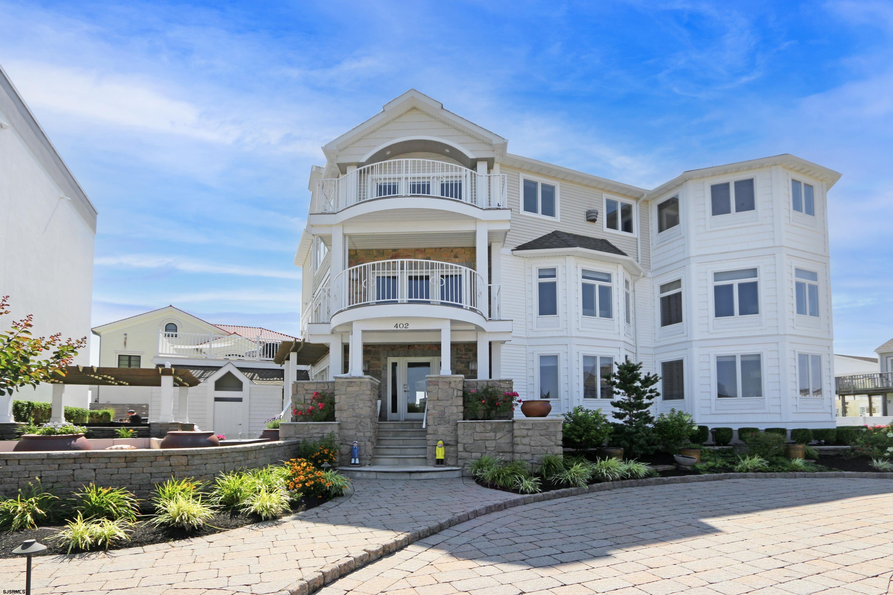 a front view of a residential apartment building with a yard