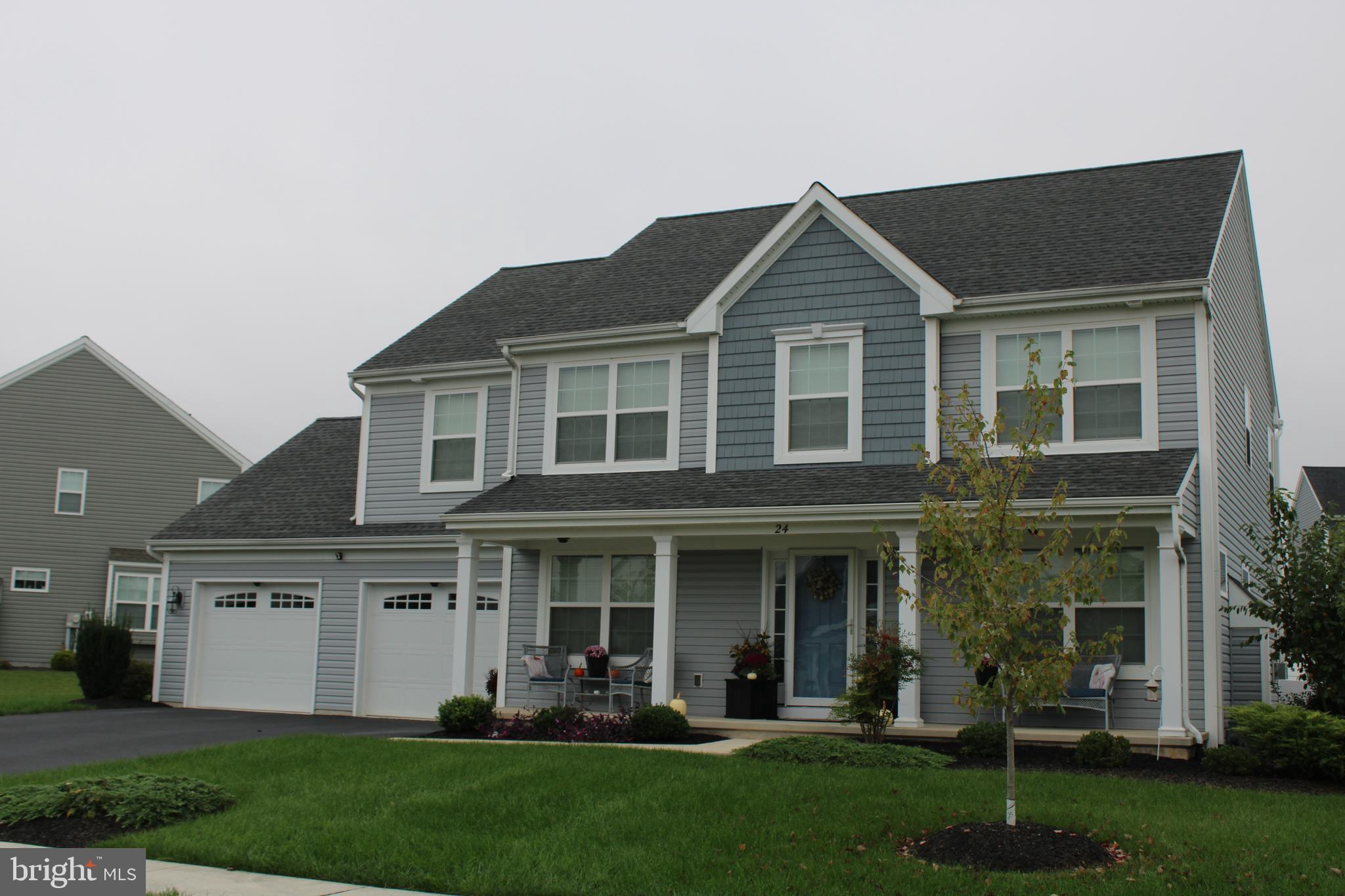 a front view of a house with a yard and porch