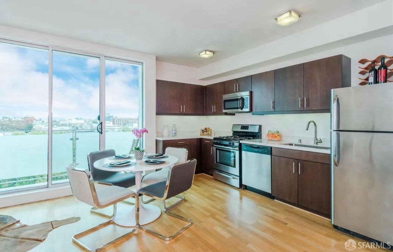 a kitchen with a refrigerator a stove top oven and a view of kitchen