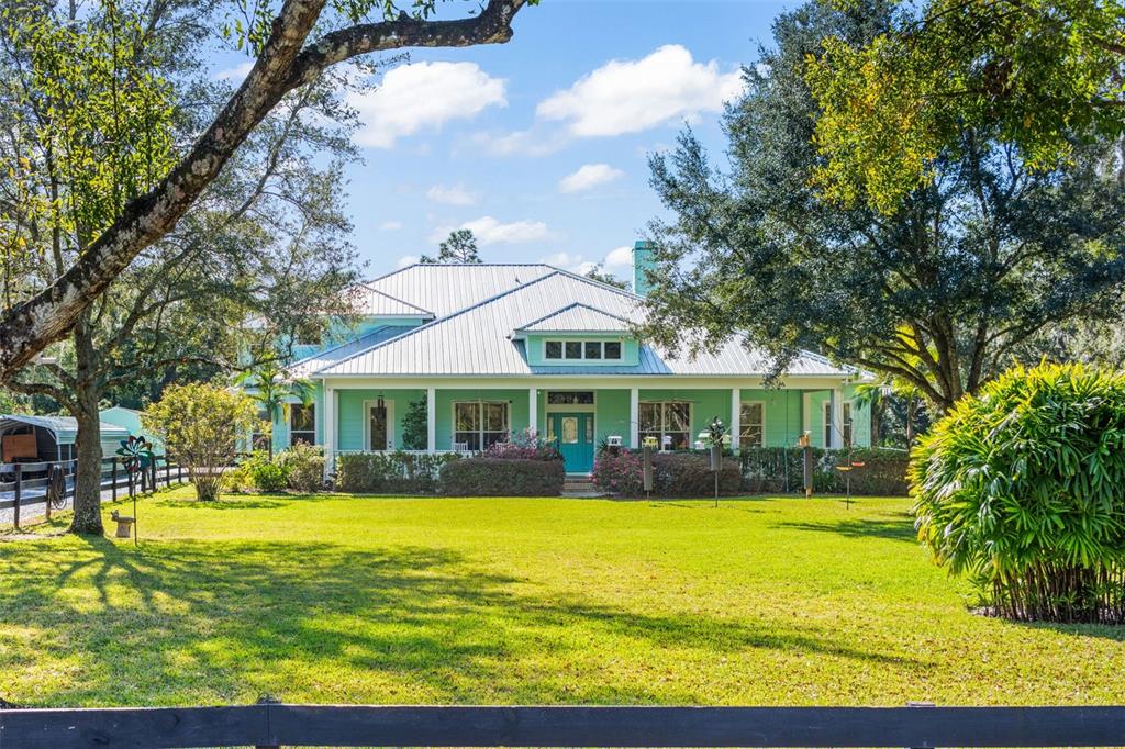 a front view of house with yard and green space