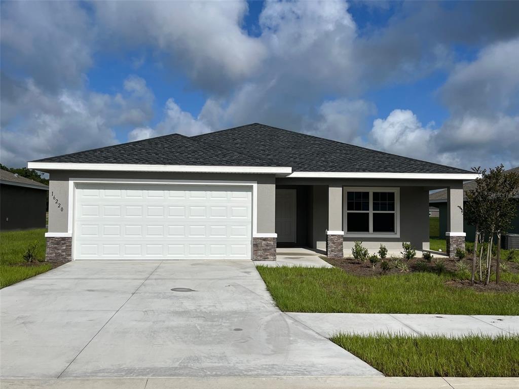 a front view of house with garage and yard