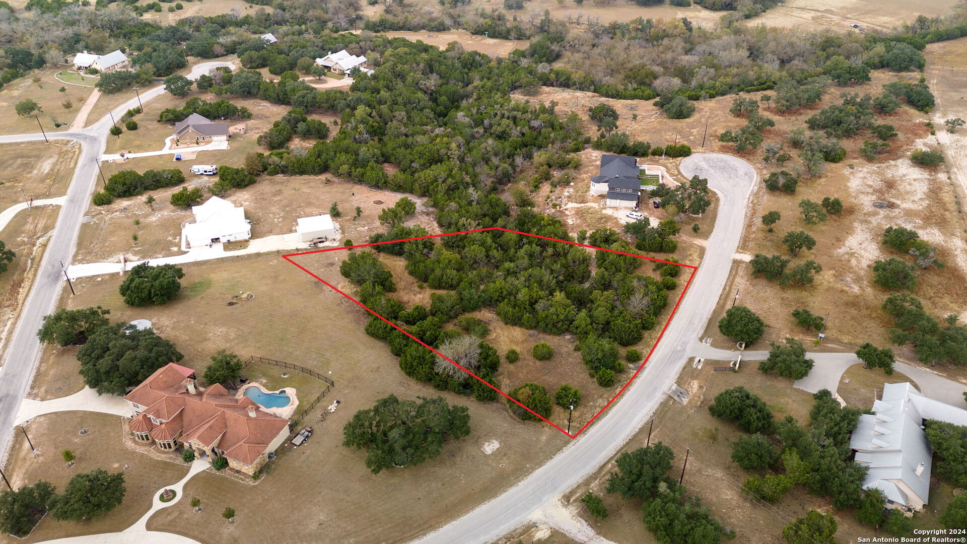 an aerial view of residential houses with outdoor space