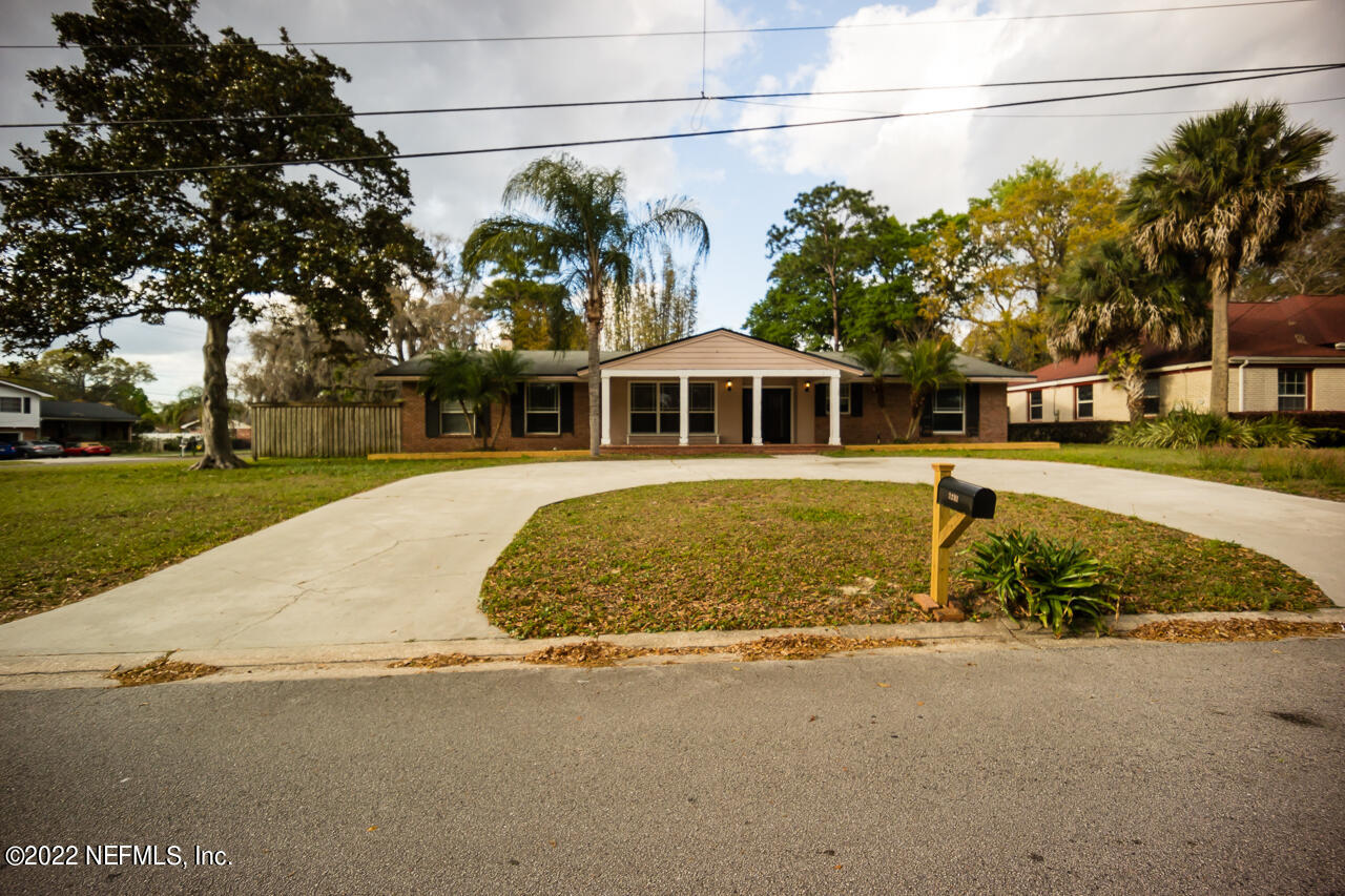 a view of a building with a yard