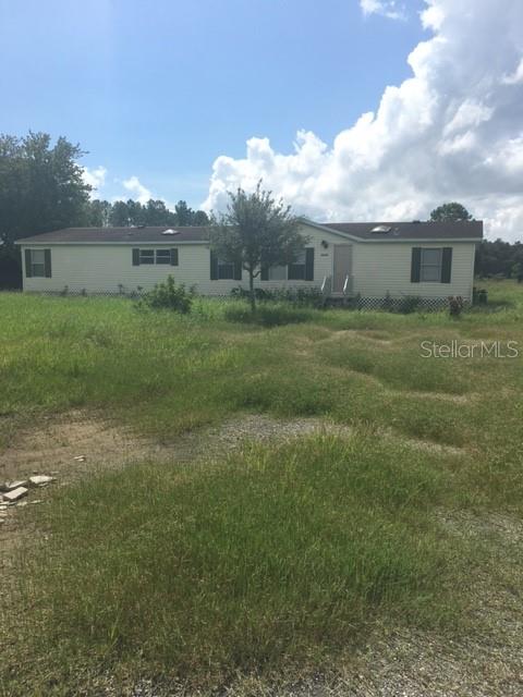 a view of a house with a back yard