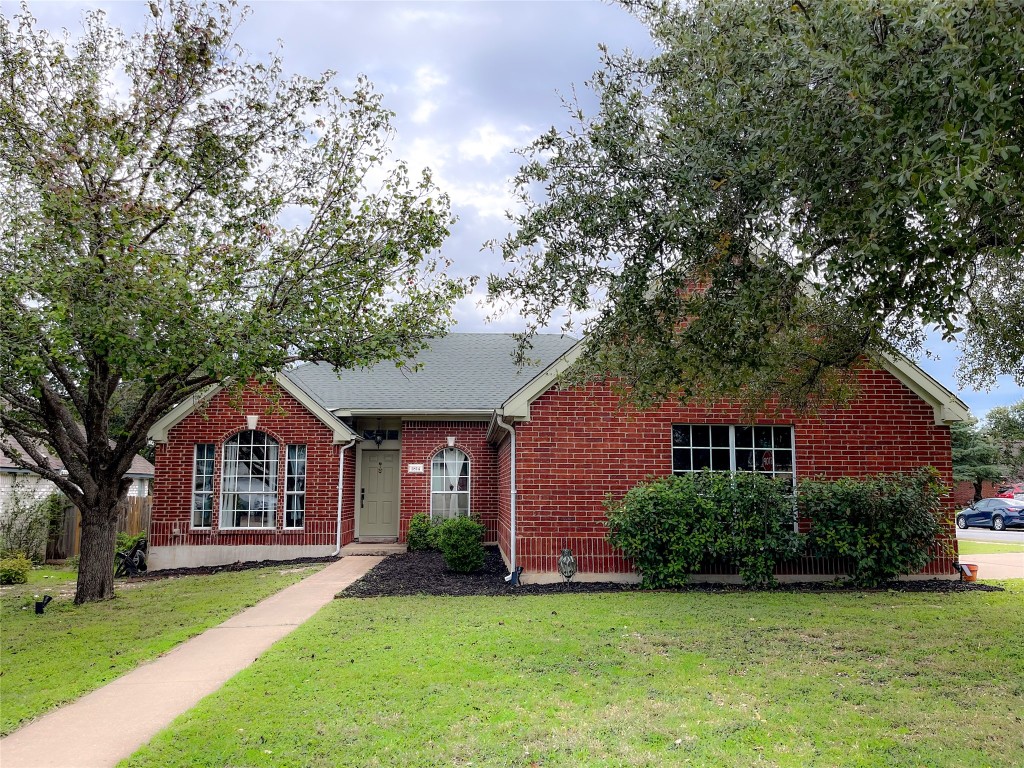 a front view of a house with a garden